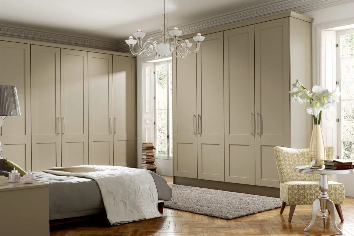 Gresham fitted bedroom in stone, with floor-to-ceiling wardrobes by Accolade Kitchens